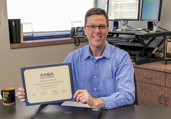 Wade McKittrick holding AASA certificate