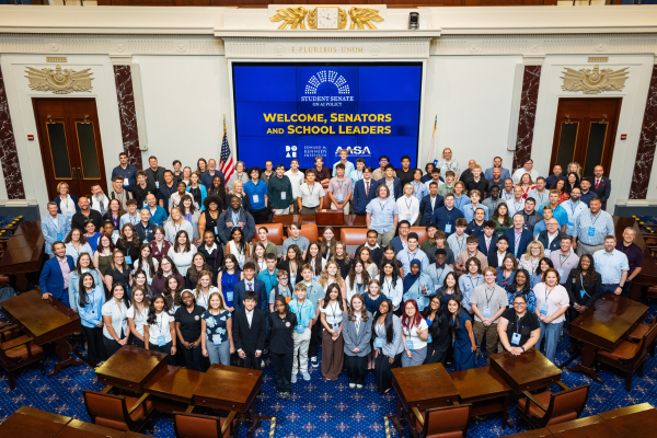 Large group of all student senators inside the Senate Chamber of the Edward M. Kennedy Institute