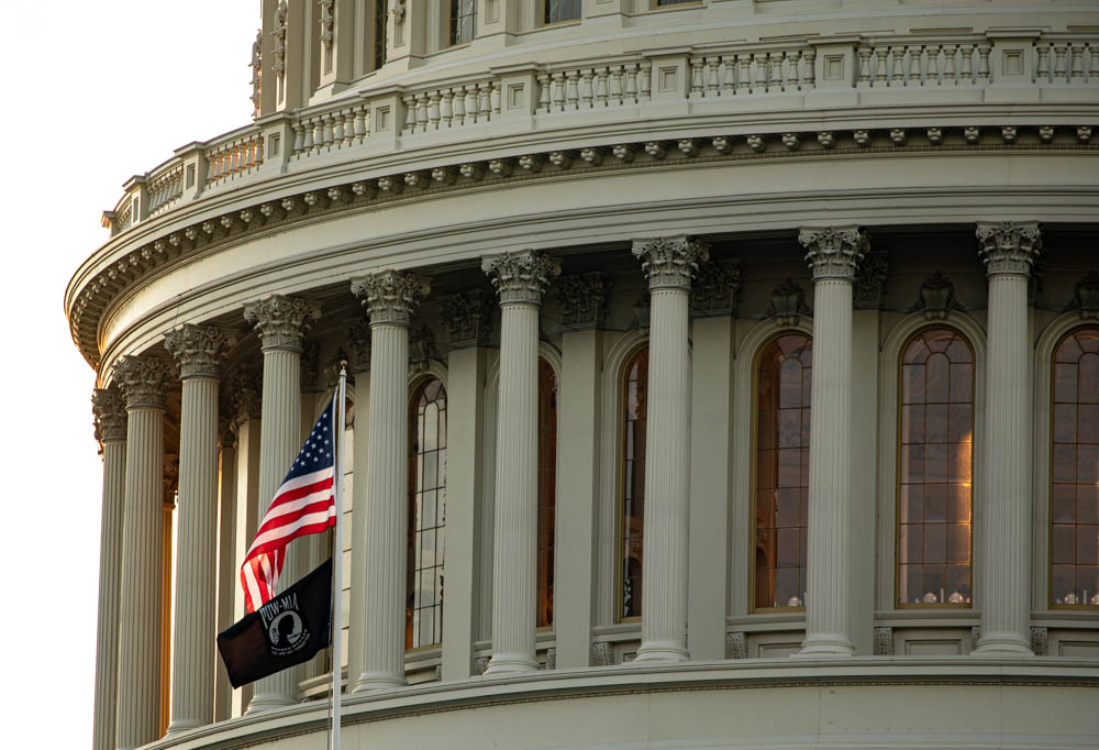 Capitol building with American flag waving