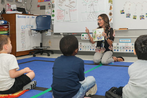 Teacher reading to children in a classroom