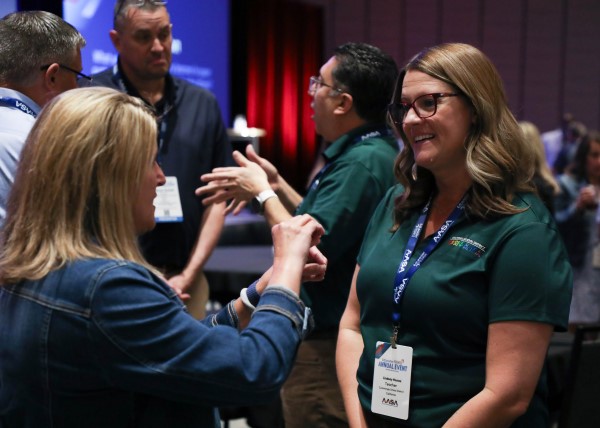 Two women talking at conference