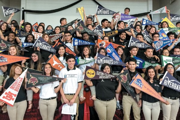 KIPP Austin students show their pennants for their colleges they have chosen