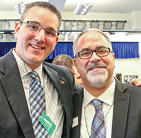 Nick Polyack and Mike Lubelfeld pose for a photo together. Both wear ties