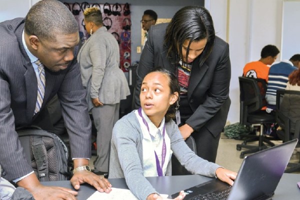 Shawn Joseph and Torrie Walker listening to student