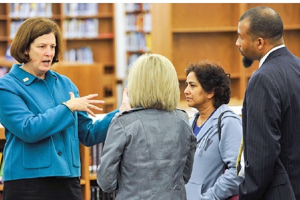 Ann Clark speaks with a couple of concerned parents