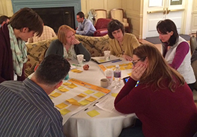 Several principles work together on projects around a table