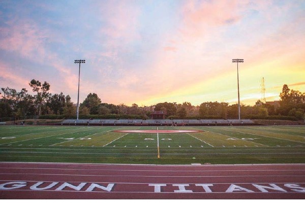 Football field with a sunset behind it