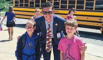 Superintendent David Hornak with students in Holt, Mich., where two elementary schools run extended-year calendars.