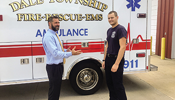Andrew Wise (left), superintendent of Olympia Community Unit School District 16 in Illinois, with Kyle, a student who earned enough college credits in a dual enrollment program to land a job with the fire department in Bloomington, Ill.