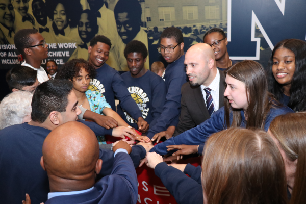 Roberto Padilla teams up with a group fo older students and administrators