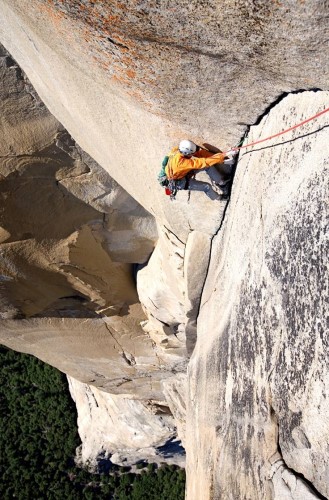 Jim Collins rock climbing on a steep rock face