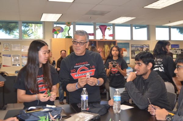 Michael Matsuda works with students in a lab