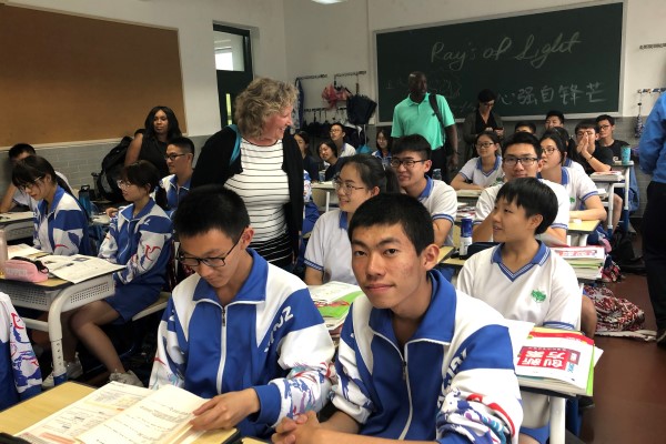 Beijing Middle School students smile from their desks