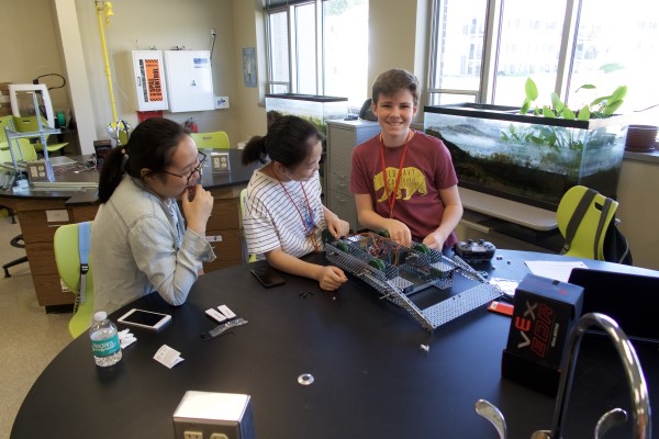 Three students work together on a STEM project
