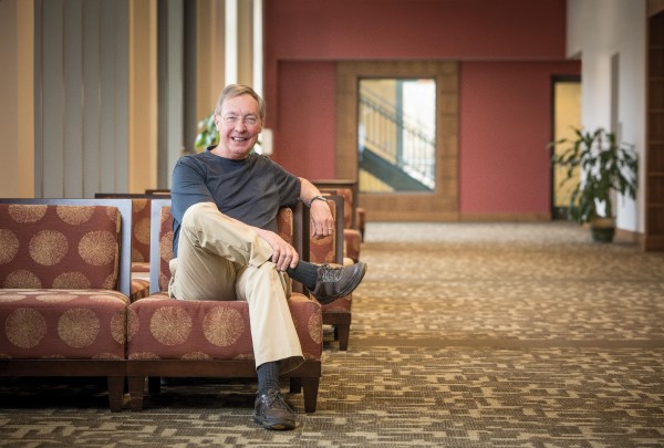 Ted Dintersmith sits on a chair in a lobby