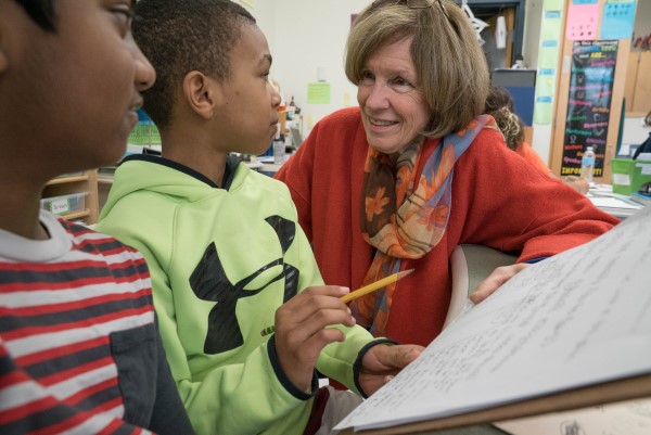 Lucy Calkins speaks with two students