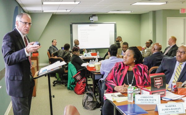 Stephen Joel addresses a room of educators seated at tables in a conference room