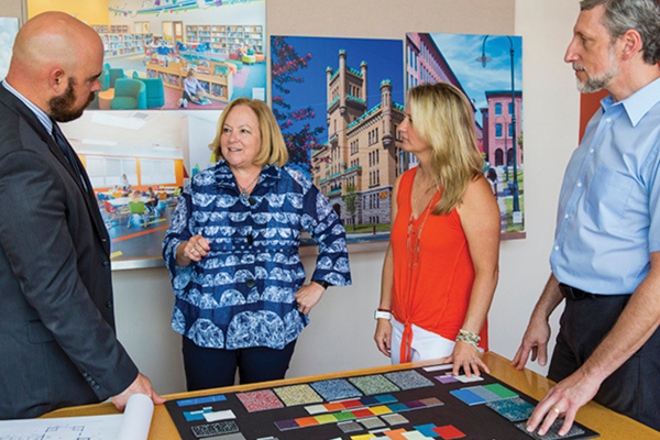 Judy Paolucci (second from left) and Mario Carreno (left) meet with an architect and interior designer to review finishing touches for Pleasant View Elementary School in Smithfield, R.I. PHOTO BY HEIDI GUMULA/DBVW ARCHITECTS