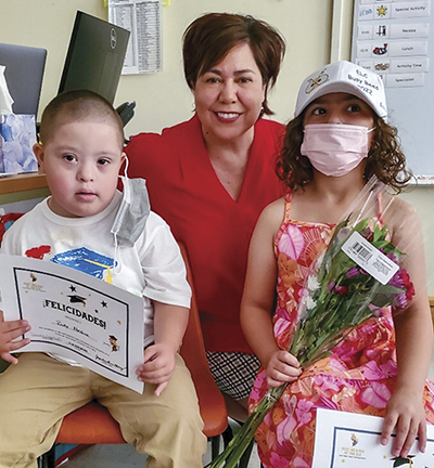 Almi Abeyta with two children sitting on her lap