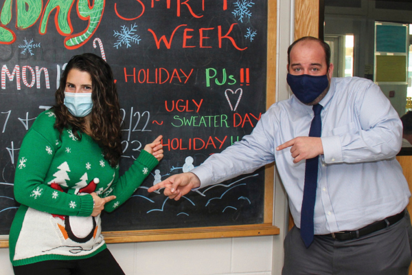 two teachers at festive blackboard