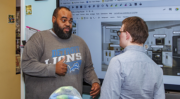 Paraprofessional in training working with student