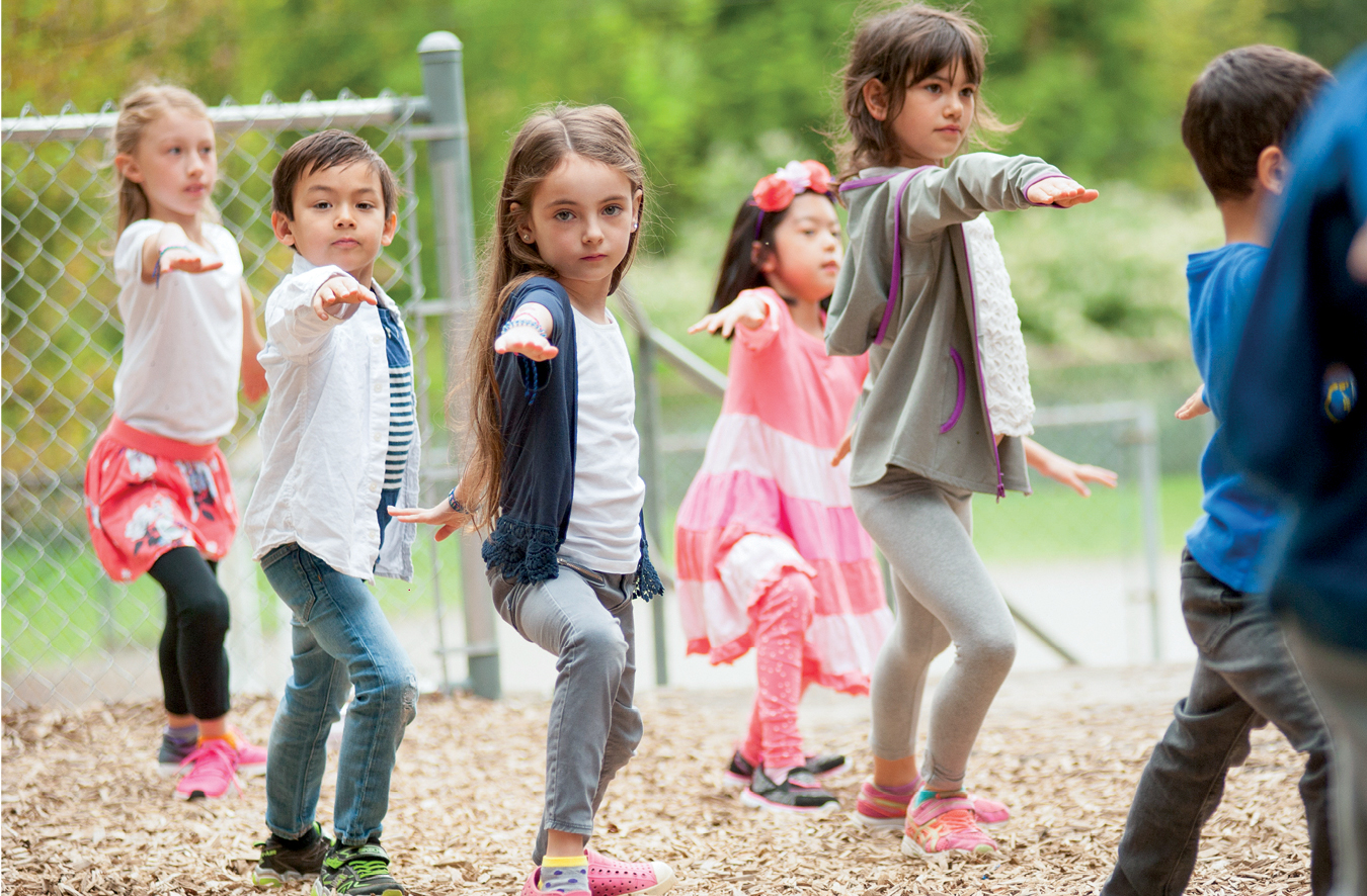 Young kids doing yoga outdoors0