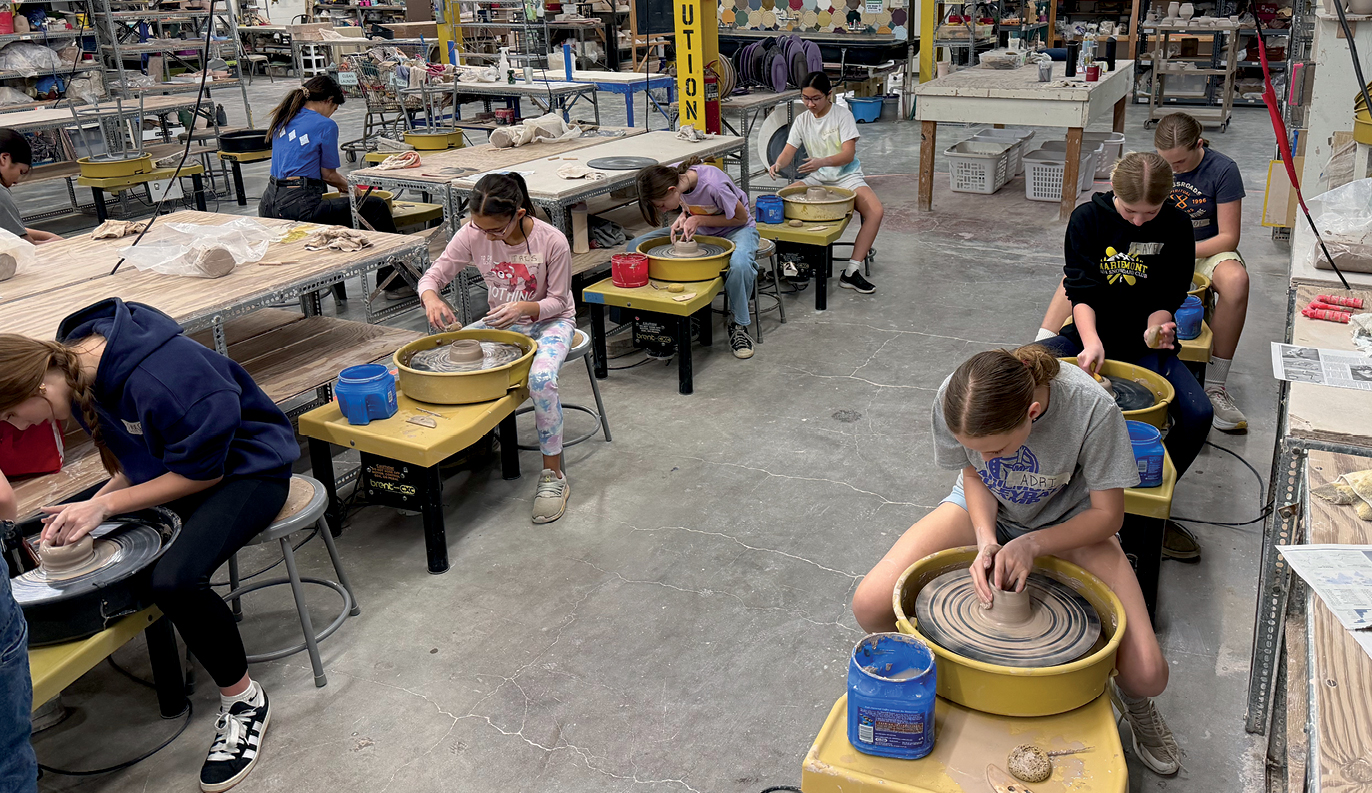 Students working on clay in a classroom workshop