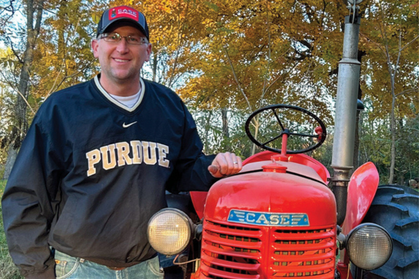 man standing with a tractor