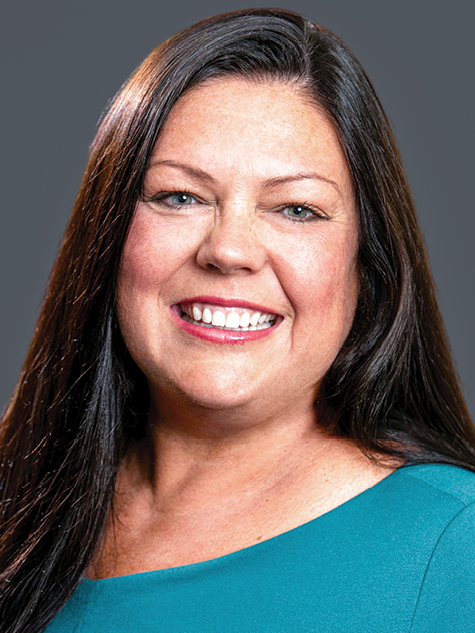 A brunette white woman smiling headshot