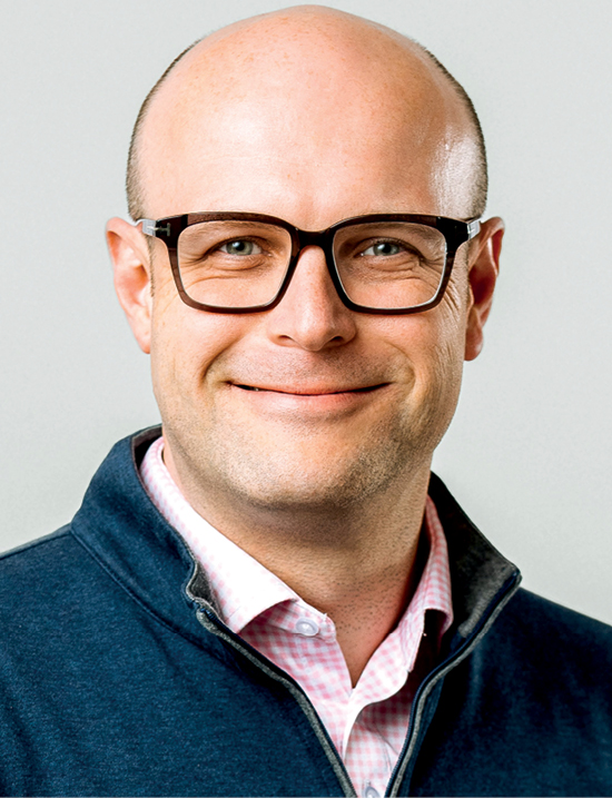 26-Chris Rose A white man wearing glasses and zip-up