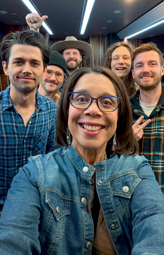 62-Sidelight - Osterhoudt with the group LANCO on their tour bus after a preshow interview A woman in jean jacket selfie with a country band