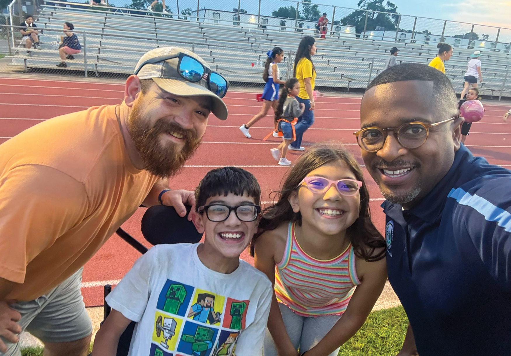 Two kids smiling photo with two adults
