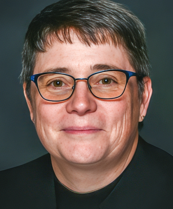 White  woman with short brown hair wearing glasses and black shirt