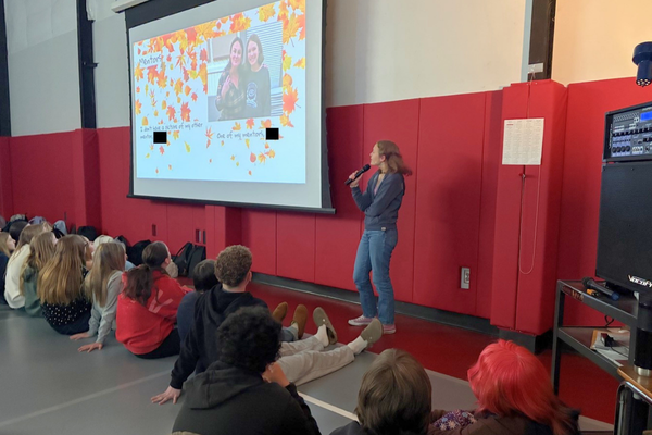 Student standing in front of a class presenting their Corbett Cardinal Project