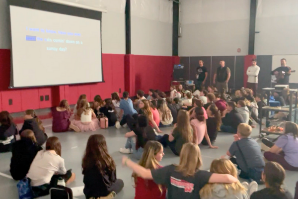 Students singing at Middle School Morning Meeting