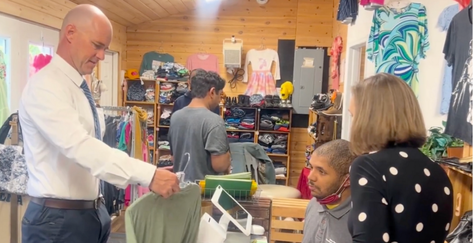 Dr. Thomas Toohey works with our Edison students as they practice real-world skills at our We Care Thrift Shop.