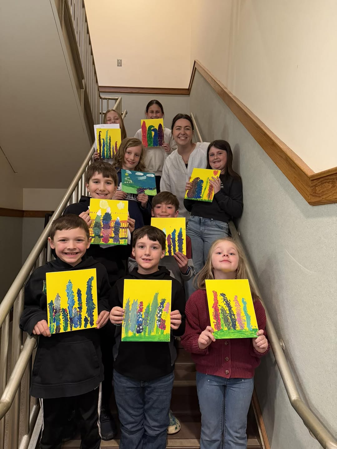 Family Art at Gorham Public Schools 9 students standing with art pieces during Family Art time at Gorham Public Schools