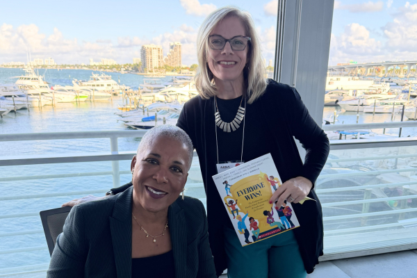 Heather Collins and Karen Mapp with Karen Mapp's book, Everyone Wins!