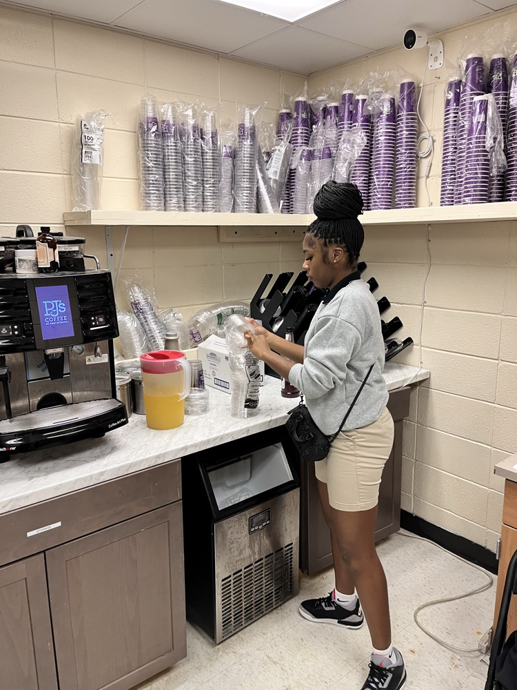 A high school student working as a barista at a community coffee shop