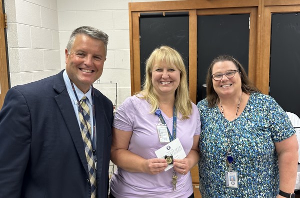 Superintendent Nicely celebrating teacher Ginger Davis and her over 25 years of service