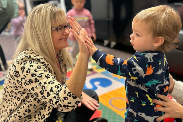 Westbrook Elementary Nebraska Adult and young child high five at Westbrook Elementary in Nebraska