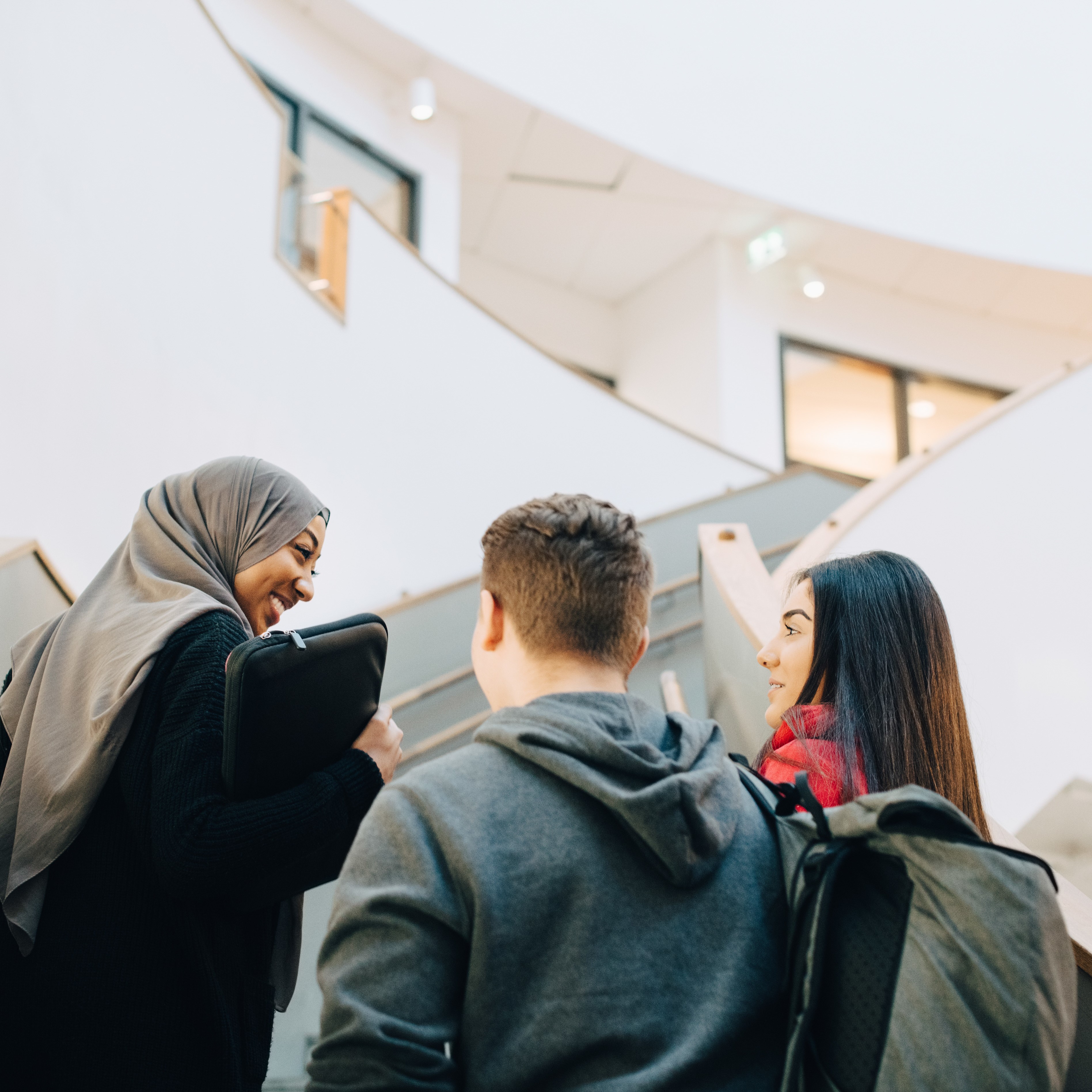 Students walking up the stairs of a school building