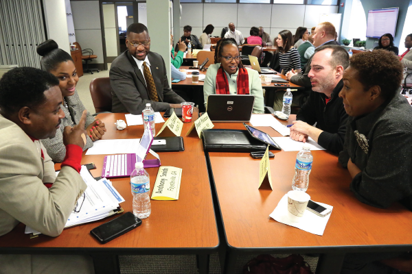 Leaders around a table in a program