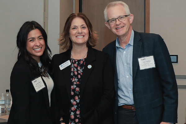 Three district leaders smiling